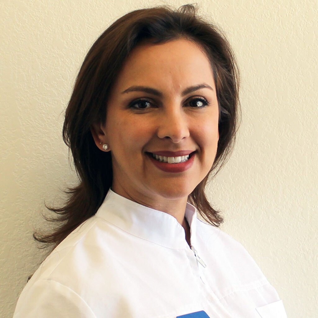 Dr. Sandra Rios, the best dentist that accepts Medi-Cal in Oceanside CA, consulting with a patient.